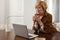 Businesswoman. Female With Laptop. Mature Woman Remote Homework Concept. Model in Brown Jacket And Eyeglasses.