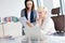 Businesswoman with female manager reading book at desk in office