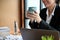 Businesswoman or female office worker sipping a coffee at her office desk. cropped