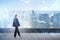 Businesswoman in formal suit walking along rooftop, terrace in N