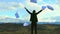 Businesswoman girl standing on top of mountain with hands up, throwing in sky sheets of paper, documents