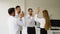 Businesswoman giving a high five to male colleague in meeting. Business professionals high five during a meeting in