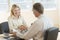 Businesswoman Greeting Colleague In Office