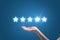 Businesswoman hand holding five stars isolated