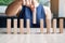 Businesswoman hand placing or pulling wooden Dominoes