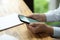 Businesswoman hands in white shirt holding modern smart cellphone