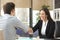 Businesswoman handshaking with client closing deal