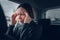 Businesswoman having migraine headache in company car