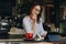 Businesswoman having a video chat on digital tablet while sitting at coffee shop. Female sitting at window table at cafe and