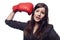 Businesswoman hitting herself with boxing gloves