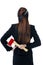 Businesswoman holding axe behind her back