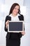 Businesswoman holding blank chalkboard