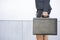 Businesswoman holding briefcase outdoors