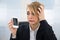 Businesswoman holding broken smartphone