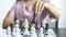 Businesswoman holding chess to take down opposing players