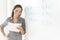 Businesswoman Holding Document While Leaning On Whiteboard In Of