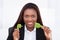 Businesswoman holding green plug in office