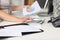 Businesswoman Holding Piechart While Using Calculator At Desk