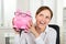 Businesswoman Holding Piggybank With Eyeglasses