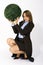 Businesswoman holding plant