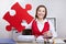 Businesswoman holding red jigsaw puzzle piece
