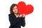 Businesswoman holding red paper heart