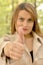 Businesswoman holding thumb up