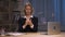 Businesswoman holds contract in her hands and squeeze his. Woman in black business suit sits at table in office