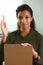 A businesswoman holds a hand up with a pen