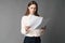 Businesswoman holds the papers in her hands and reads what is written there. on gray background.