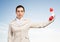 Businesswoman holds vintage red phone on distance