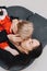 Businesswoman hugs with daughter on the floor and kisses her