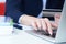 Businesswoman inputting her password and login to carry out online banking operation on laptop pc in the office. Woman`s