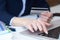 Businesswoman inputting her password and login to carry out online banking operation on laptop pc in the office. Woman`s