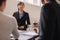 Businesswoman interacting with colleagues during presentation