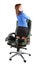 Businesswoman kneeling on chair