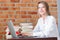 Businesswoman with laptop computer and books