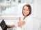 Businesswoman with laptop in office