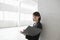 Businesswoman Leaning Against Wall With Paperwork