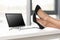 Businesswoman legs crossed on table near laptop and eyeglasses