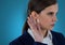 Businesswoman listening gossip against blue background