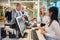 Businesswoman Looking At Female Staff At Airport Check-in