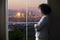 Businesswoman in Los Angeles Looking at Office Window