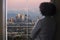 Businesswoman in Los Angeles Looking at Office Window