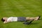 Businesswoman lying in park with laptop