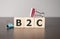 Businesswoman made word b2c with wood building blocks