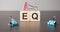 Businesswoman made word eq with wood building blocks
