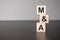 Businesswoman made word m and a with wood building blocks
