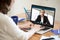 Businesswoman making video call to business partner using laptop