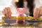 Businesswoman Measuring Piggybank With Measuring Tape